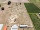 Aerial view of an undeveloped lot with green crops to the right and building foundations to the bottom at 4400 Walker Lake Rd, Bartow, FL 33830