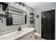 Modern bathroom with a black framed mirror, open shelves, and a sleek white vanity at 4400 Walker Lake Rd, Bartow, FL 33830