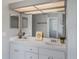 Bright bathroom featuring double sinks with white cabinetry and a large well-lit mirror at 4400 Walker Lake Rd, Bartow, FL 33830