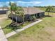 Inviting single-story home with palm trees, landscaped beds, and covered front porch at 4400 Walker Lake Rd, Bartow, FL 33830