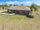Lovely single-story home with lush landscaping, palm trees, and a cozy front porch at 4400 Walker Lake Rd, Bartow, FL 33830