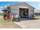 A spacious, gray concrete block garage featuring an open garage door and exterior storage at 4400 Walker Lake Rd, Bartow, FL 33830
