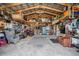 A cluttered, finished garage interior with exposed rafters and plenty of open storage space at 4400 Walker Lake Rd, Bartow, FL 33830