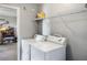 Functional laundry room with appliances, a wire shelf, and access to another room at 4400 Walker Lake Rd, Bartow, FL 33830