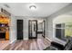 Cozy seating area leading to kitchen and bedroom through black paneled doors at 4400 Walker Lake Rd, Bartow, FL 33830
