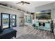Open living room featuring wood-look flooring, ceiling fan, and sliding glass doors leading to an outdoor pool at 4400 Walker Lake Rd, Bartow, FL 33830
