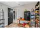Functional pantry with shelving, a mini-fridge, and access to other rooms, providing convenient storage and connectivity at 4400 Walker Lake Rd, Bartow, FL 33830