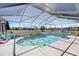 Lovely screened-in pool area with a slide and chairs, perfect for outdoor relaxation at 4400 Walker Lake Rd, Bartow, FL 33830