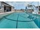 Beautiful view of a sparkling pool with a slide and screened enclosure and blue sky at 4400 Walker Lake Rd, Bartow, FL 33830