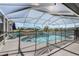 Screened-in pool with a slide, lounge chairs, and view of a farm in the background at 4400 Walker Lake Rd, Bartow, FL 33830