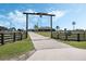 Ranch-style entrance with longhorn skull overhead leading up a long driveway to the gray ranch home at 4400 Walker Lake Rd, Bartow, FL 33830