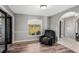 A sitting area with hardwood floors and neutral paint adjoins a hall and exterior view at 4400 Walker Lake Rd, Bartow, FL 33830