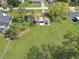 Aerial view of the property with a long driveway, green lawn and mature trees along the fence line at 51 Park Ln, Debary, FL 32713