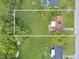 Aerial view of a house with an expansive backyard, showcasing the property's boundaries and surrounding greenery at 51 Park Ln, Debary, FL 32713