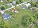 Aerial view showing the home situated on a generous lot surrounded by mature trees and well-maintained lawns at 51 Park Ln, Debary, FL 32713