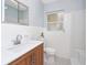 Bathroom with a white vanity, stylish fixtures, and tiled shower at 51 Park Ln, Debary, FL 32713