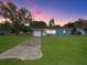 Charming blue home with a well-manicured lawn and a long driveway leading to an attached garage at 51 Park Ln, Debary, FL 32713