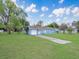 Inviting single-story home with a spacious front yard and mature trees on a sunny day at 51 Park Ln, Debary, FL 32713