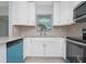 Well-lit kitchen featuring white cabinets, granite countertops, and modern appliances at 51 Park Ln, Debary, FL 32713