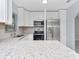 Bright kitchen features white cabinets, stainless steel appliances, and a stylish backsplash at 51 Park Ln, Debary, FL 32713