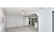 Open-concept living room with ceiling fan, neutral paint, and grey tile flooring throughout at 51 Park Ln, Debary, FL 32713