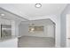 Inviting open-concept living area featuring grey tile flooring, kitchen bar, and natural light at 51 Park Ln, Debary, FL 32713