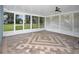 Relaxing screened porch with patterned brick flooring overlooking the yard at 51 Park Ln, Debary, FL 32713