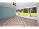 Open screened porch with brick flooring, great for outdoor lounging at 51 Park Ln, Debary, FL 32713