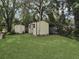 Storage shed with charming detailing in a mature backyard setting at 51 Park Ln, Debary, FL 32713