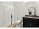 Bathroom featuring a glass-enclosed shower, dark wood vanity with granite countertop, contemporary fixtures and tile flooring at 611 Marsh Reed Dr, Winter Garden, FL 34787