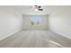 Bedroom with a ceiling fan and a window, with neutral carpet and white walls at 611 Marsh Reed Dr, Winter Garden, FL 34787