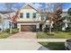 Charming two-story home boasts a well-maintained lawn, mature landscaping and a brick paved driveway leading to a two-car garage at 611 Marsh Reed Dr, Winter Garden, FL 34787