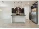 Modern kitchen with granite countertops, stainless steel appliances, dark wood cabinets, and a center island with pendant lighting at 611 Marsh Reed Dr, Winter Garden, FL 34787