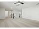 Spacious loft area with neutral carpet and a ceiling fan, leading to other rooms in the home at 611 Marsh Reed Dr, Winter Garden, FL 34787