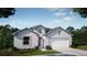 Charming single-story home featuring a two-car garage, well-manicured lawn, and neutral color palette at 6635 Lullaby Way, Mascotte, FL 34753