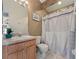 Functional bathroom with a single sink vanity, toilet, and shower-tub combo with stylish curtain at 721 Rollins Dr, Davenport, FL 33837