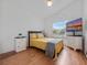 Cozy bedroom with hardwood floors, a sunny window, and a TV for relaxation, creating a peaceful retreat at 721 Rollins Dr, Davenport, FL 33837