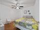 Inviting bedroom with a bed, a ceiling fan, and white walls, providing a serene and restful environment at 721 Rollins Dr, Davenport, FL 33837