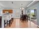 Bright dining room featuring breakfast bar seating, wooden table set, and sliding glass doors at 721 Rollins Dr, Davenport, FL 33837