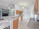 Eat-in kitchen with breakfast bar, tile floors, and views of the living area at 721 Rollins Dr, Davenport, FL 33837