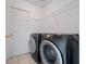 Well-equipped laundry room features modern front-load washer and dryer, maximizing efficiency and convenience at 721 Rollins Dr, Davenport, FL 33837