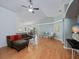 Open-concept living room featuring vaulted ceilings, wood floors, and an elegant sectional couch at 721 Rollins Dr, Davenport, FL 33837