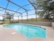 Sparkling pool surrounded by a screened enclosure, providing a tranquil outdoor escape at 721 Rollins Dr, Davenport, FL 33837