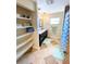 Bathroom featuring a dual sink vanity with modern fixtures, a shower, and open shelves for storage at 760 Eastridge Dr, Orange City, FL 32763