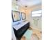 Bathroom featuring a dual sink vanity with granite countertops and modern fixtures and lighting at 760 Eastridge Dr, Orange City, FL 32763