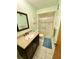 Bathroom featuring a vanity with dark wood cabinets and a granite countertop with a large walk-in shower at 760 Eastridge Dr, Orange City, FL 32763