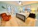 A comfortable bedroom with a metal bedframe, ceiling fan, and side tables at 760 Eastridge Dr, Orange City, FL 32763
