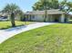 Exterior view of a single-story home with a long driveway and well-manicured lawn at 760 Eastridge Dr, Orange City, FL 32763