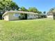 Lovely single-story house surrounded by a well-maintained lawn and mature trees at 760 Eastridge Dr, Orange City, FL 32763