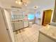 Bright kitchen with stainless steel appliances, granite countertops, and a sink with a view to the backyard at 760 Eastridge Dr, Orange City, FL 32763